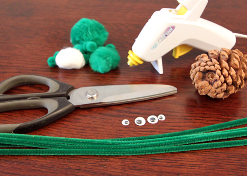 Craft supplies for pine cone spider: pipe cleaners, googly eyes, pom poms